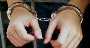 Arrest-image-handcuffs-behind-bars-e1429170345182